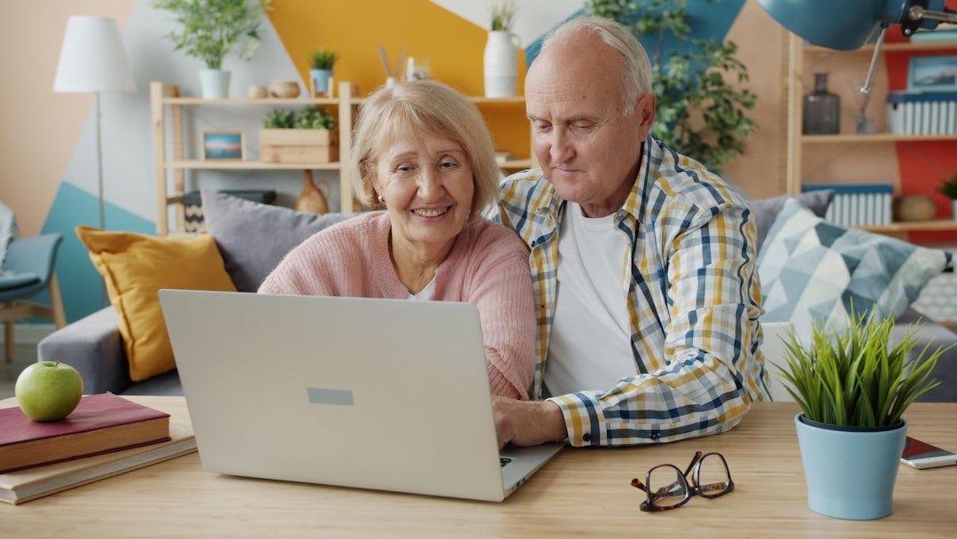 Senior couple reading educational Medicare and planning resources online at home in Georgia