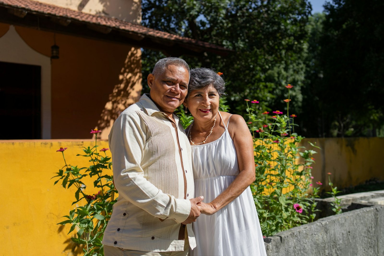 Senior homeowners standing outside their Georgia home while weighing a property decision