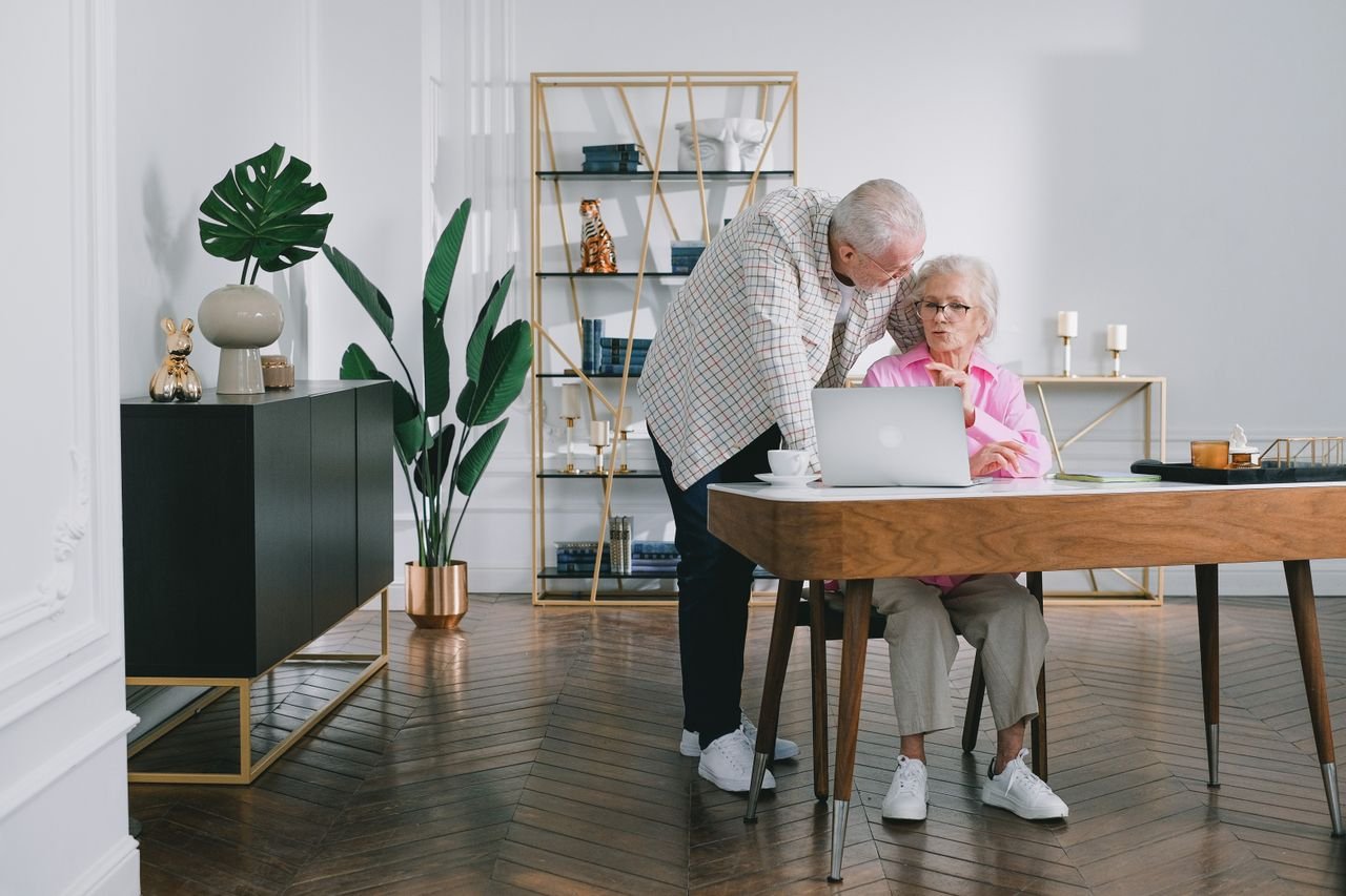 Senior couple reading educational materials together at home