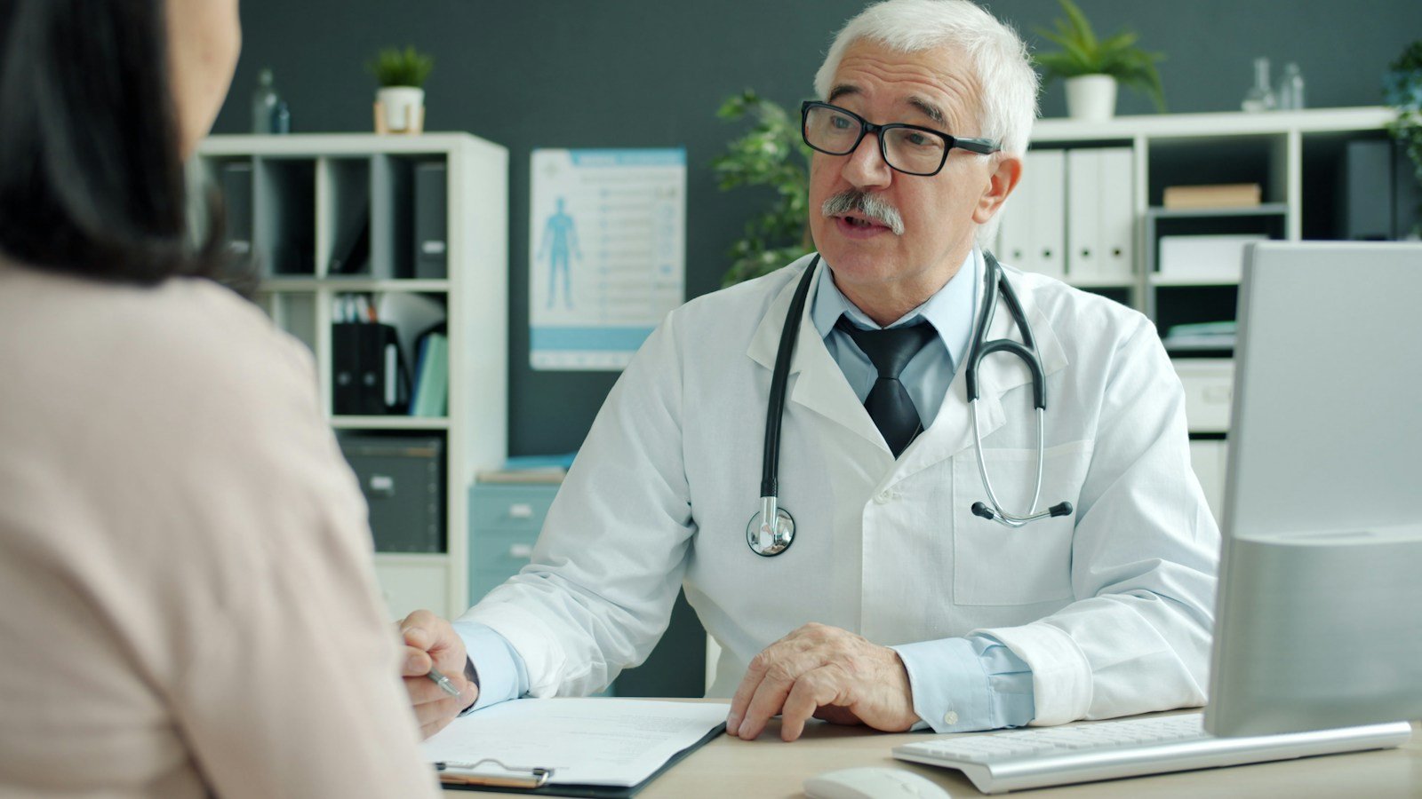 Senior doctor discussing care with a patient, reflecting the hospital coverage Medicare Part A provides